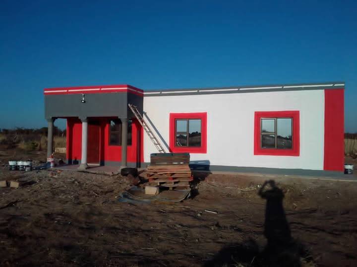 Completed house with aluminium windows, red and white finish