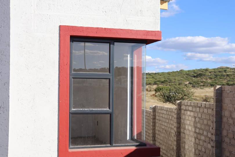 Aluminium window against a deep red facade, Namibia