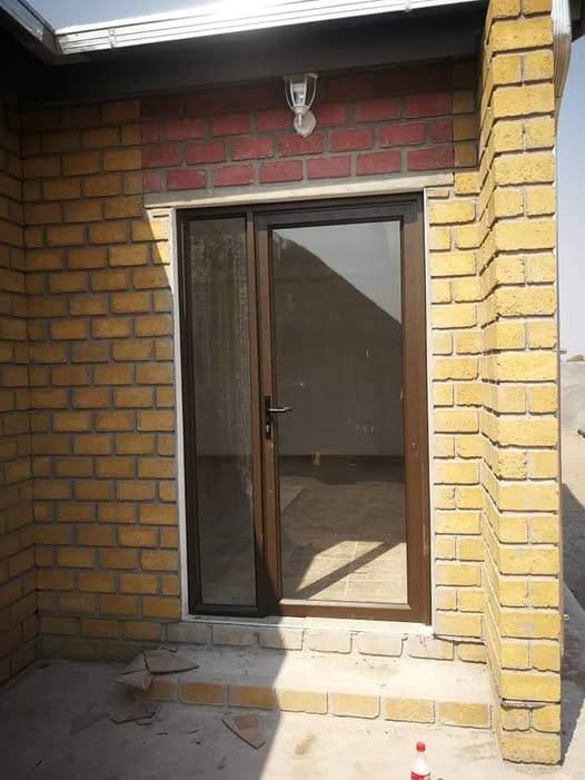 Aluminium entrance door frame fitted in a brick building, Namibia